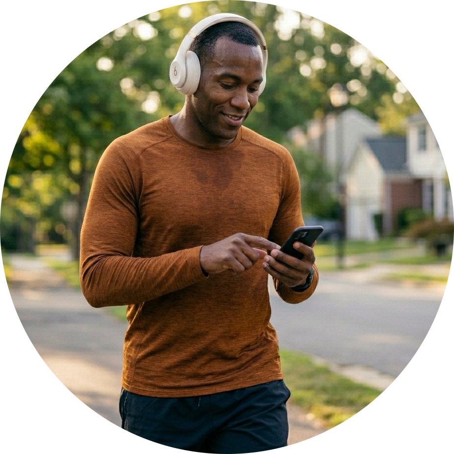 man jogging texting with headphones